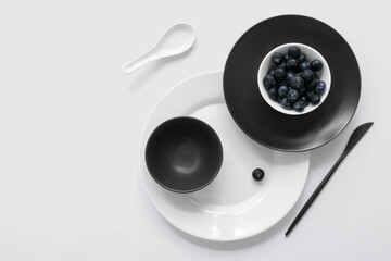 Table setting in white and black colors on light background