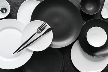 Table setting in white and black colors on dark background