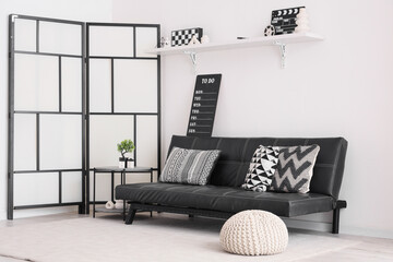 Stylish interior in black and white colors with modern sofa