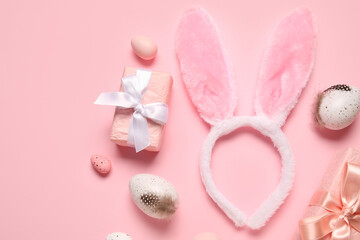 Bunny ears with Easter eggs and gift boxes on pink background