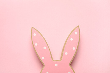Wooden Easter bunny ears on pink background