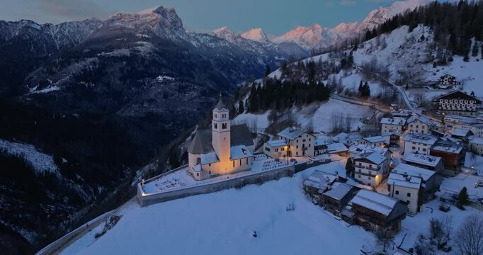 Aerial drone view of the Eglise de Sainte-Lucie in the Colle Santa Lucia comune in Dolomites, Italy