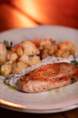 Baked turkey and cauliflower are a delicious dish on the menu at the restaurant. A beautiful and delicious photo for a menu, culinary website, or an advertisement for catering establishments.