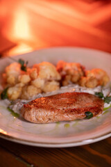 Baked turkey and cauliflower are a delicious dish on the menu at the restaurant. A beautiful and delicious photo for a menu, culinary website, or an advertisement for catering establishments.