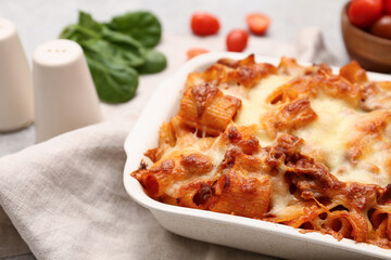 Baking dish with tasty pasta and cheese, closeup