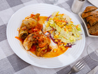 Appetizing chicken drumsticks with lettuce and corn grains
