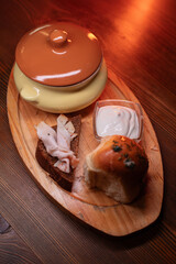 Restaurant dish borscht, delicious bread with bacon, sour cream, bun. A delicious photo for a menu, culinary website, or an advertisement for catering establishments.