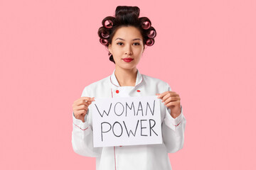 Female Asian chef holding paper with text WOMAN POWER on pink background