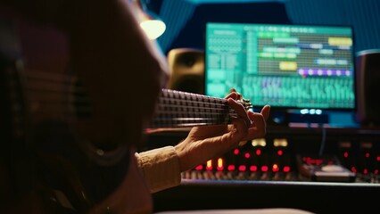 Skilled artist guitarist recording a new song with electro acoustic guitar, composing and editing...