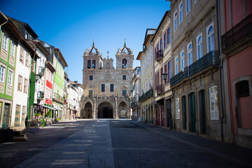 Fototapeta premium A quiet street with colorful buildings leading to the Braga Cathedral, Portugal.