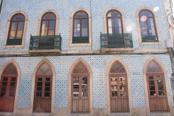 Ornate tiled facade with arched windows and balconies in Águeda, Portugal.
