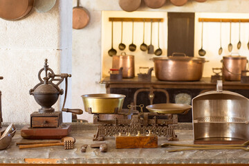 Collection of vintage copper kitchen tools and utensils in a traditional Portuguese setting.