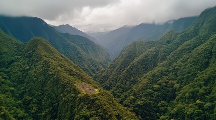 Fototapeta premium Stunning view of Machu Picchu ruins surrounded by lush green Andean mountains.