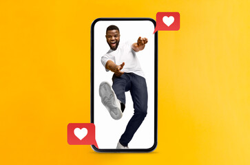 A joyful person interacts with their smartphone, expressing love and excitement. The yellow...