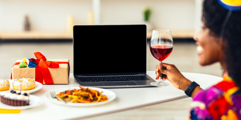 Online Holiday Celebration. Happy African American Couple Having Video Call Celebrating Birthday Or New Year Distantly, Sitting At Laptop With Wine At Home. Cropped, Selective Focus On Computer