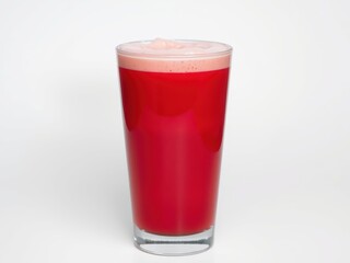 Red creamy drink in a tall glass