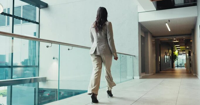 Walking, back and conference with business woman for tradeshow, corporate seminar and travel. Keynote speaker, convention center and professional with person in hotel lobby for confidence and pride