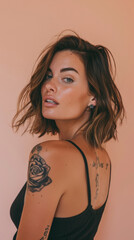 Playful model with tattoos and stylish over shoulder look