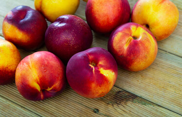 Fresh organic nectarine on wooden background, fruit vegan food