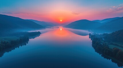 Fototapeta premium Serene Sunrise Over Misty Mountain Lake