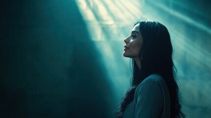 Woman praying, ethereal light, dark background, hope, faith