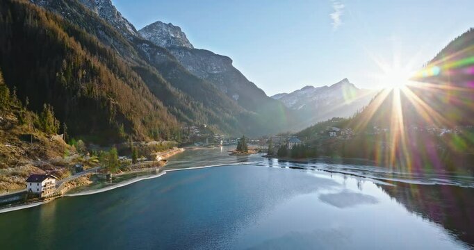 Aerial drone view of the Alleghe village with Lake Alleghe, in the province of Belluno, Dolomites, Italy