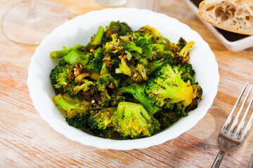 Green fried broccoli in a bowl. Top view.