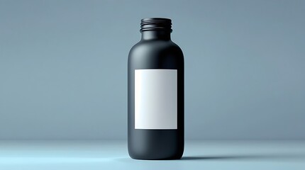 A modern black bottle with a white label on a simple blue backdrop, showcasing minimalist packaging design and providing a versatile product mockup template.

