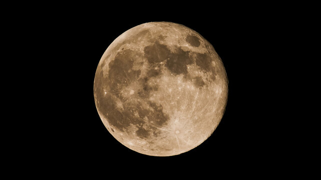 Beautiful photo of full super moon, Hunters moon isolated against a black night sky background with copy space.