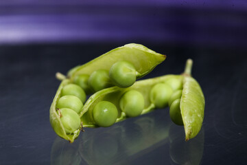 Two Pod of green Pea , which are part of the legume family, which consists of plants that produce pods with seeds inside. Photographed on interesting background