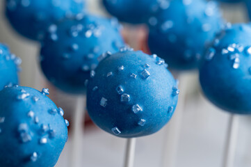 Blue cake pops with sugar crystals for party.