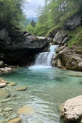Naklejka premium A small waterfall trickling into a clear river surrounded by boulders