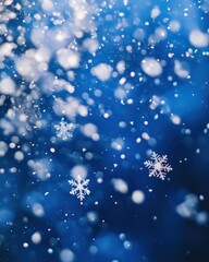 Obraz premium A vibrant photo of snowflakes falling gently against a deep blue sky, creating a magical effect