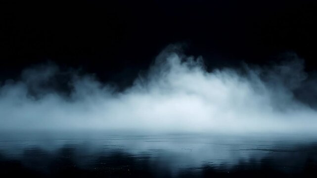 Mysterious fog rolling over reflective water surface in dramatic night scene