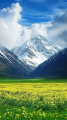 Majestic snow-capped mountains rise above a vibrant yellow flower-filled valley under a blue sky