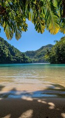 Serene tropical beach with clear blue water, lush green mountains, and vibrant foliage in view