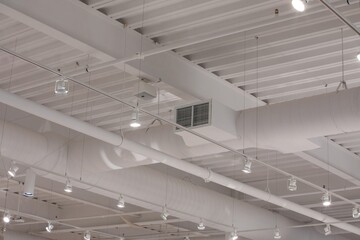 White ceiling of a modern commercial building with track lighting