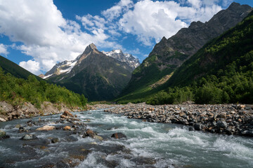 View of the Dombay-Ulgen gorge in the mountains of the North Caucasus near the village of Dombay on a sunny summer day, Karachay-Cherkessia, Russia