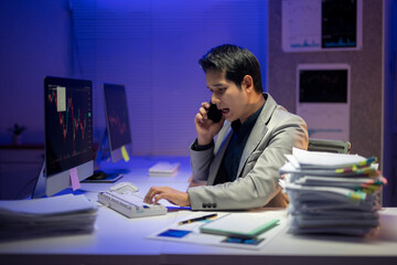 The desk is cluttered with papers and a keyboard