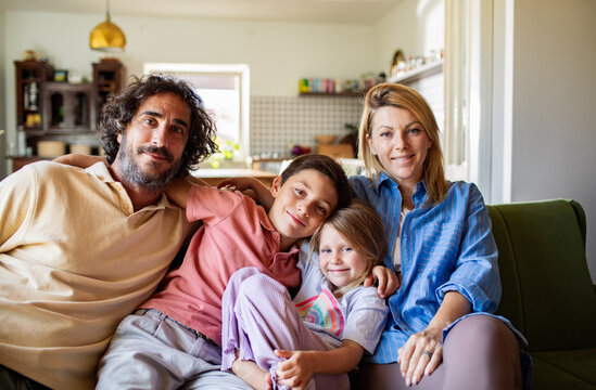 Selfie portrait of a happy family on the couch in cozy living room