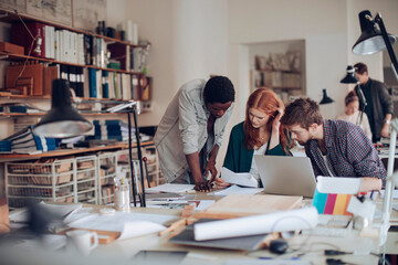 Obraz premium Group of young architects working on a project together in the office