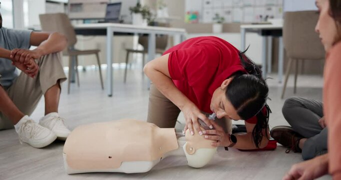 First aid, learning and mannequin with people in cpr workshop for training, healthcare and rescue breathing. Paramedic, pocket mask and teaching with person in class for emergency and open airway