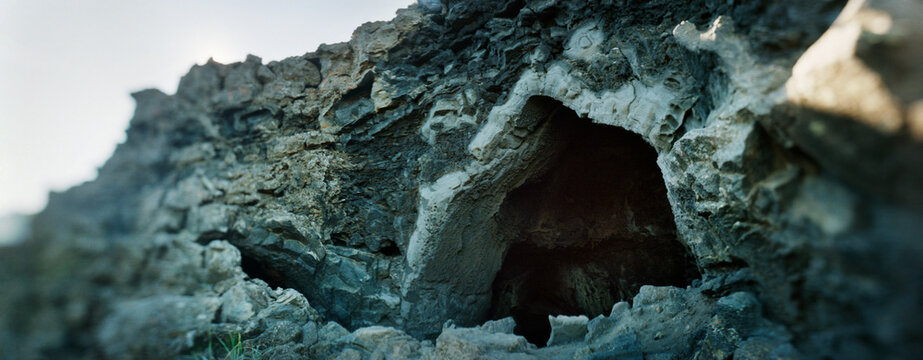 Panoramic view of the opening to a lava cave, Grjotagja Rift cave, Myvatn Lake Region, Iceland.