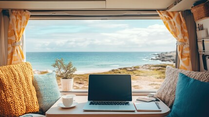 A sleek mobile office setup inside a camper van with a laptop, notebook, and a scenic window view. Copy space.