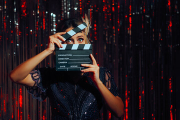 Roaring 20s Actress Holding a Film Slate Feeling Excited. Beautiful cinema starlet shooting a scene...
