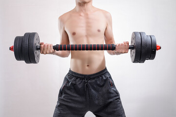 Strong Man Lifting Heavy Dumbbell in Fitness Studio Environment