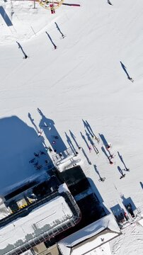 Aerial drone view of a ski resort in Col dei Baldi, Alleghe, in the Dolomites, Italy in daylight. Vertical