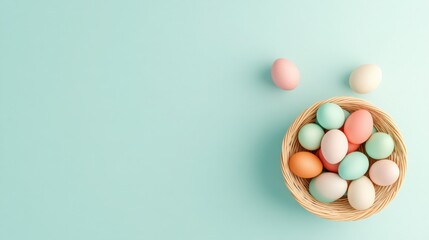 Obraz premium Pastel-colored eggs in a wicker basket on a light blue background. A festive Easter scene.