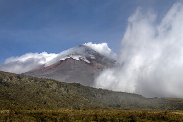 Clouds blowing over Cotopaxi Volcano, which is erupting with a small ash plume, in Cotopaxi National Park, outside of Machachi, Ecuador