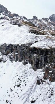 Aerial drone view of Portavescovo covered in snow, in Arabba, Italy. Vertical